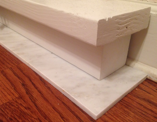 Hearth of a marble tile, a 4 x 4 post and 2 inch thick lumber